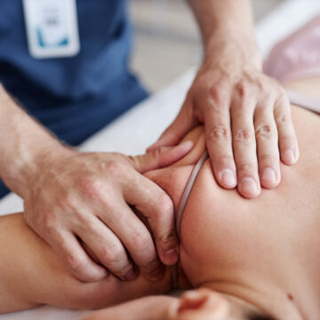 Therapist massaging back of patient