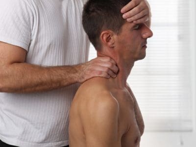 Man having chiropractic back and neck adjustment. Osteopathy, Acupressure, Alternative medicine, pain relief concept. Physiotherapy, sport injury rehabilitation