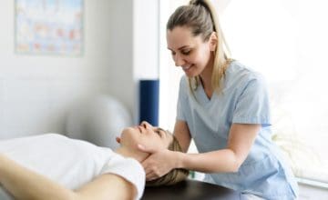 Modern rehabilitation physiotherapy woman worker with woman client