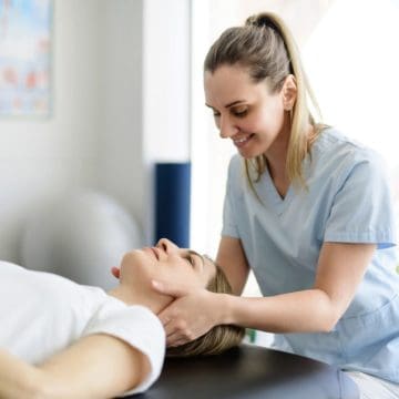 Modern rehabilitation physiotherapy woman worker with woman client