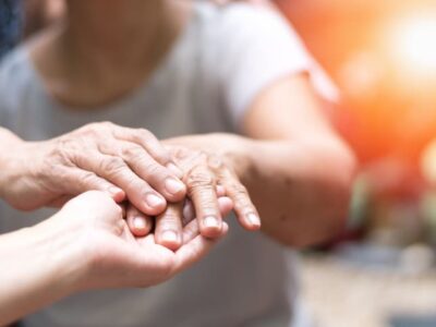 Geriatric doctor or geriatrician concept. Doctor physician hand on happy elderly senior patient to comfort in hospital examination room or hospice nursing home or wellbeing county. Geriatric doctor or geriatrician concept. Doctor physician hand on happy elderly senior patient to comfort in hospital examination room or hospice nursing home or wellbeing county.